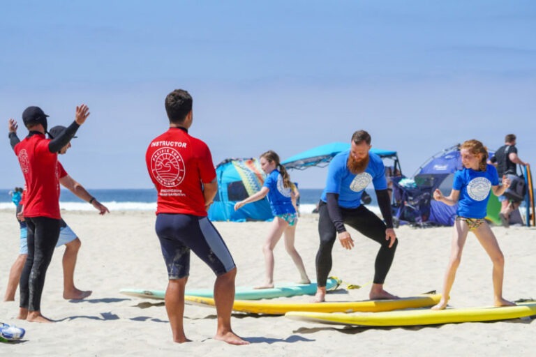 Surf instructors teaching kids surfing fundamentals
